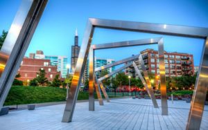 West Loop park with metal structures in front of buildings near Hotel Chicago Downtown, Autograph Collection