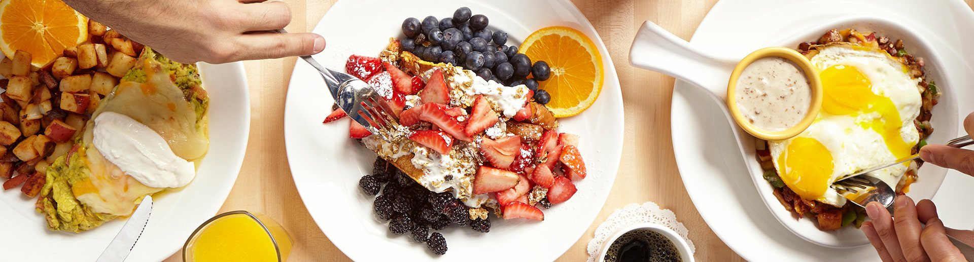 French toast with berries, eggs over easy and omelet