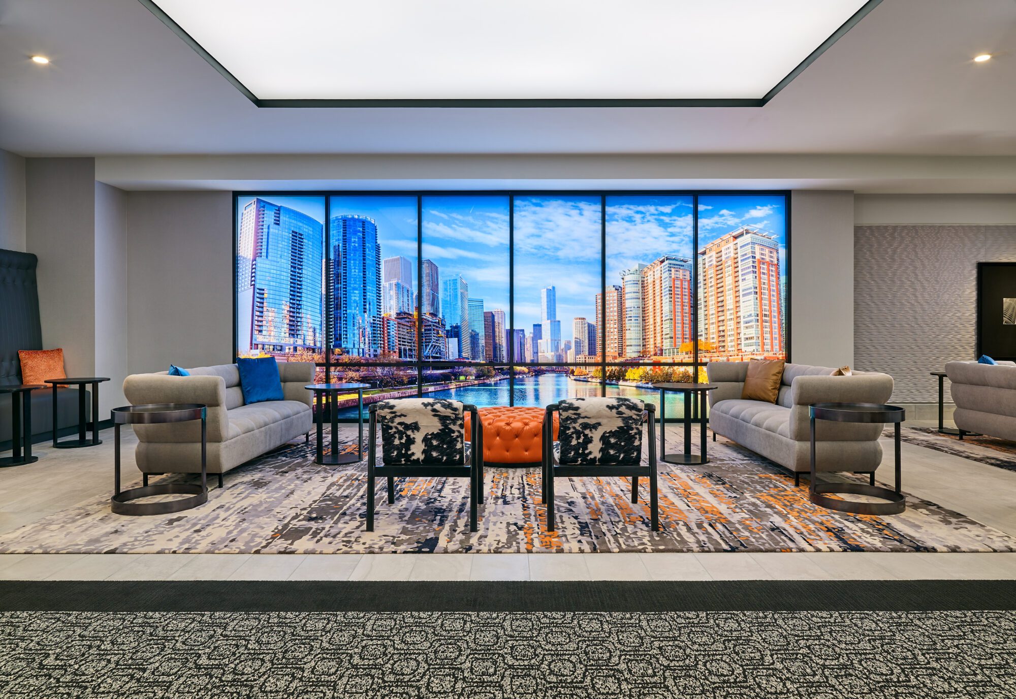 Prefunction space with grey seating and modern artwork of chicago at Hotel Chicago Downtown, Autograph Collection