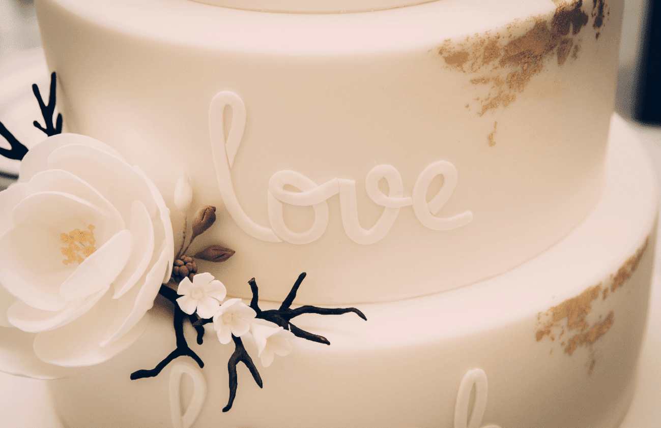 White Wedding Cake with Flowers Reading "Love" at Hotel Chicago Downtown, Autograph Collection