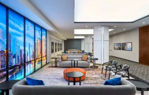 Prefunction space with seating and artwork of chicago near grey sofas at Hotel Chicago Downtown, Autograph Collection